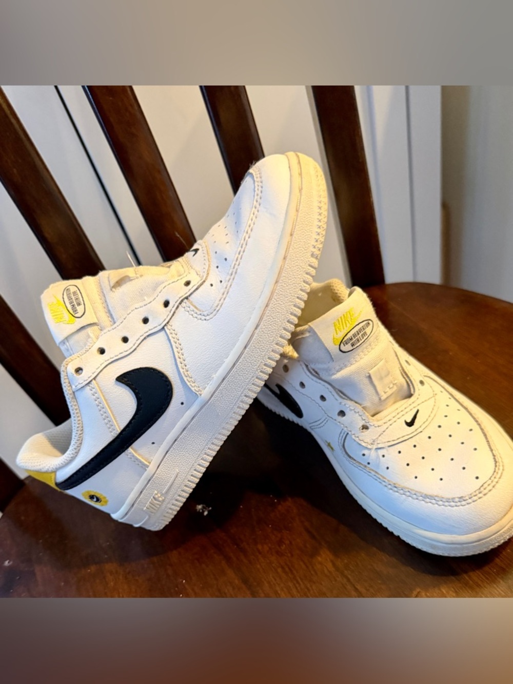 Nike White Low-Top Sneakers with Black Swoosh and Yellow Accents